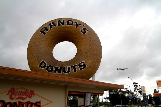 Randys donuts with plane flying overhead