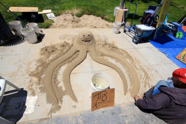An artist making sand art at the Venice Beach Boardwalk